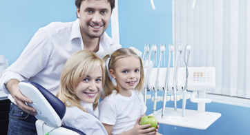 Couple with daughter in dental office