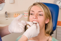 Woman getting fitted for Invisalign dental device