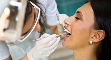 Happy woman getting dental exam