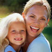 Woman and young child with missing tooth